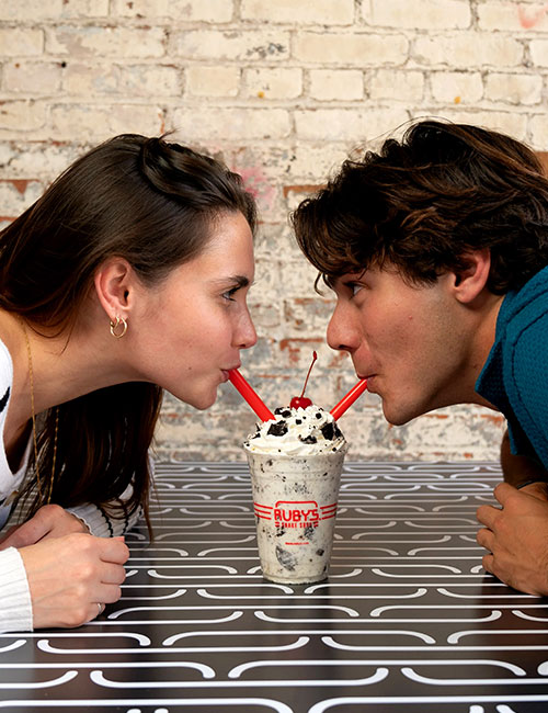 A couple sharing a shake