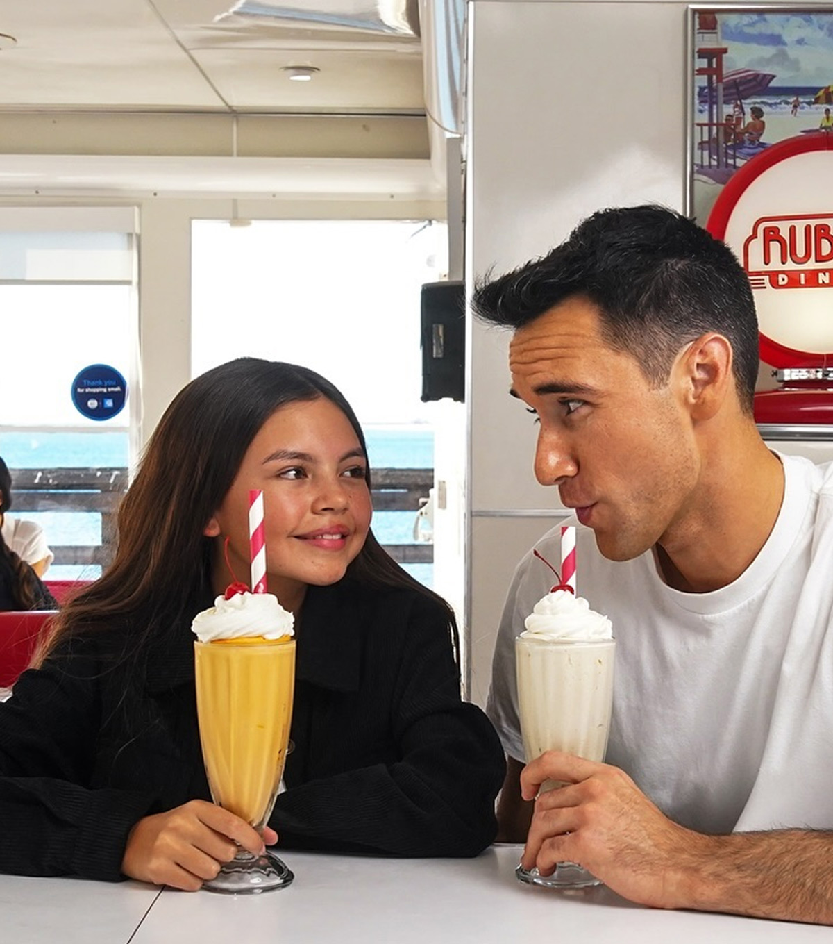 Father and daughter enjoying shakes