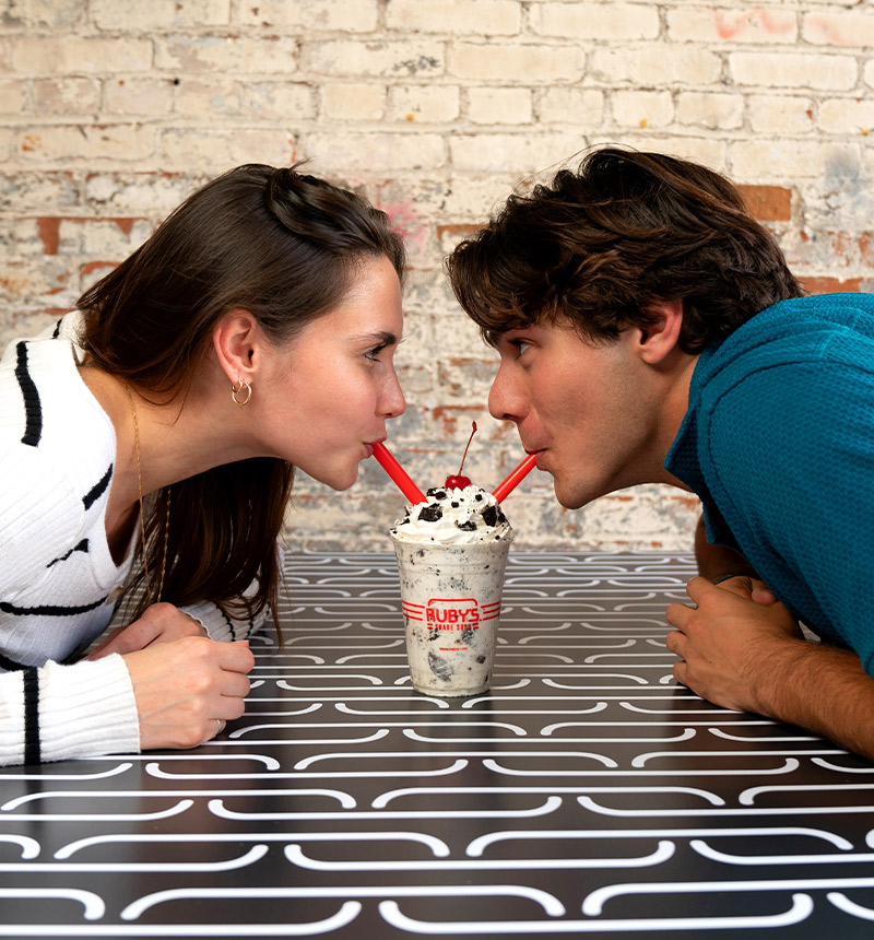 A couple sharing a shake